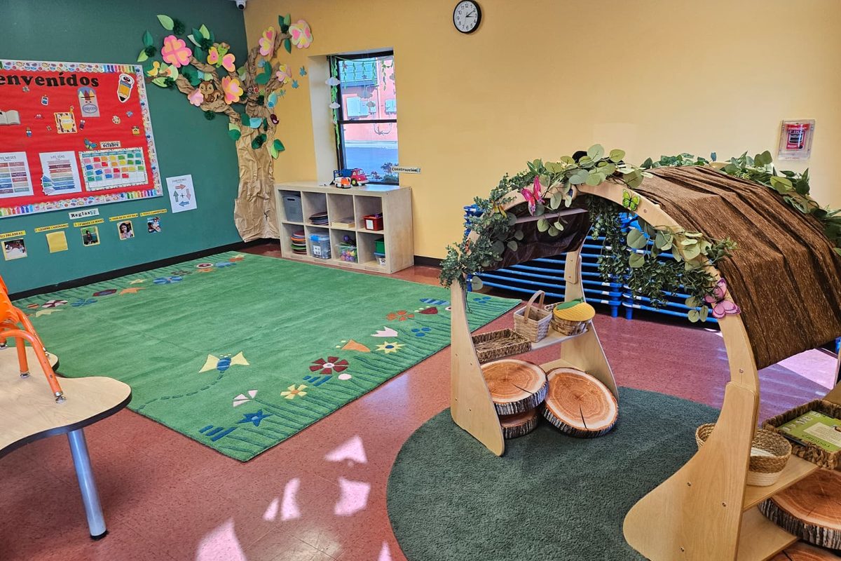 A Roseville classroom with a paper-flower tree mural and a leafy reading nook